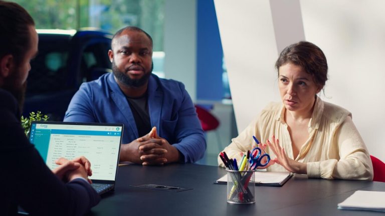 Clients chez le concessionnaire signant des documents de financement après av